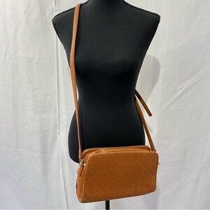 Powerland vintage monogrammed leather crossbody bag.